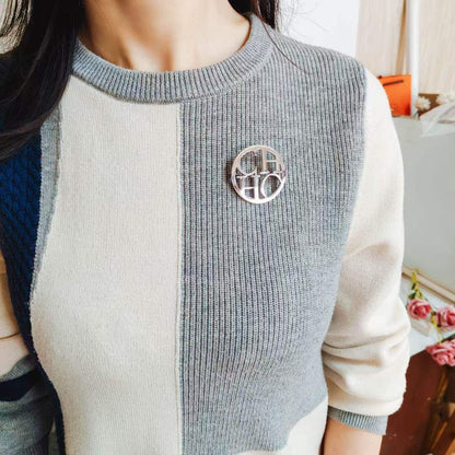 Broche acier CAROLINA HERRERA