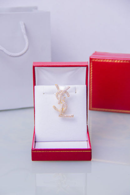 Broche doré Yves Saint Laurent